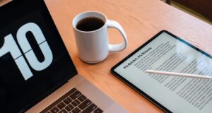 a tablet and a cup of coffee on a table